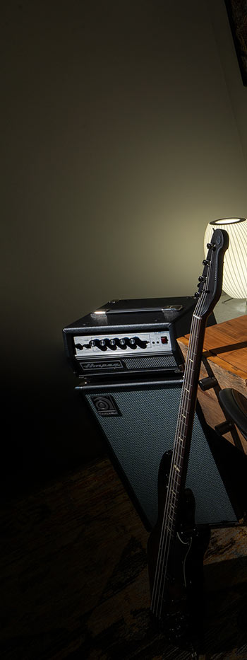 a guitar leaning against a speaker